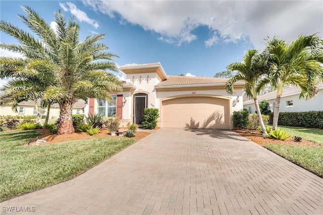 mediterranean / spanish home with a garage and a front yard