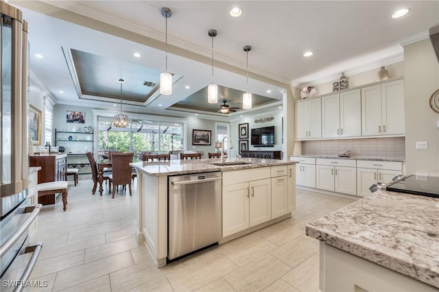 kitchen with pendant lighting, dishwasher, an island with sink, sink, and light stone countertops