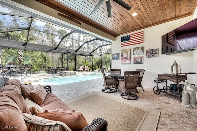 view of patio / terrace featuring pool water feature, outdoor lounge area, and glass enclosure