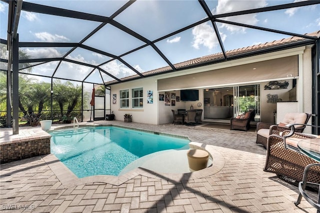 view of swimming pool featuring pool water feature, a patio area, and glass enclosure