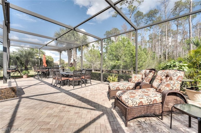 view of patio with an outdoor living space and a lanai