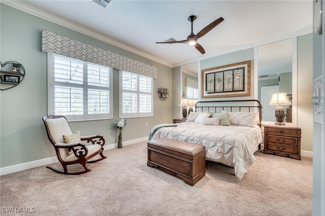 carpeted bedroom featuring crown molding and ceiling fan