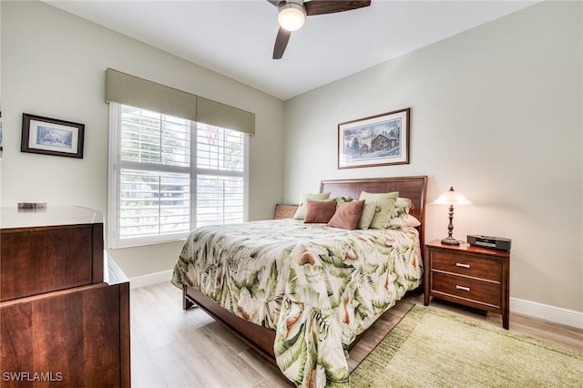 bedroom with multiple windows, ceiling fan, and light wood-type flooring