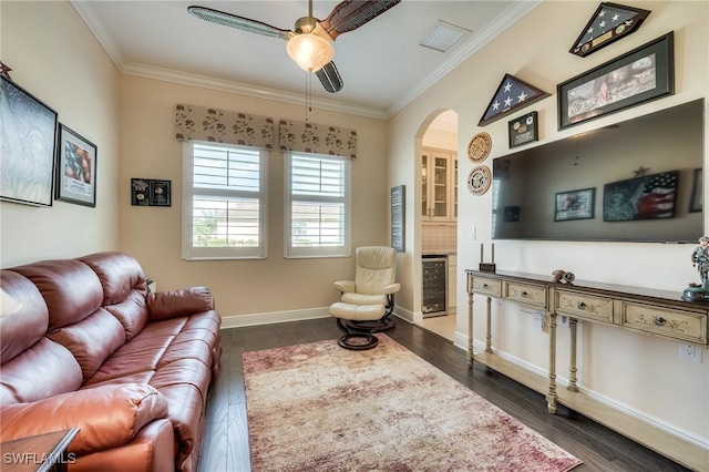 living room with crown molding, dark wood-type flooring, beverage cooler, and ceiling fan