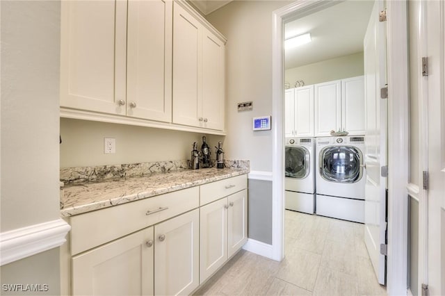 clothes washing area featuring washer and dryer