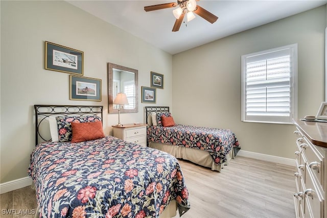 bedroom with multiple windows, light hardwood / wood-style flooring, and ceiling fan