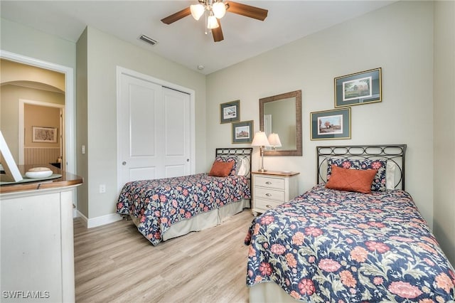 bedroom with ceiling fan, a closet, and light hardwood / wood-style flooring