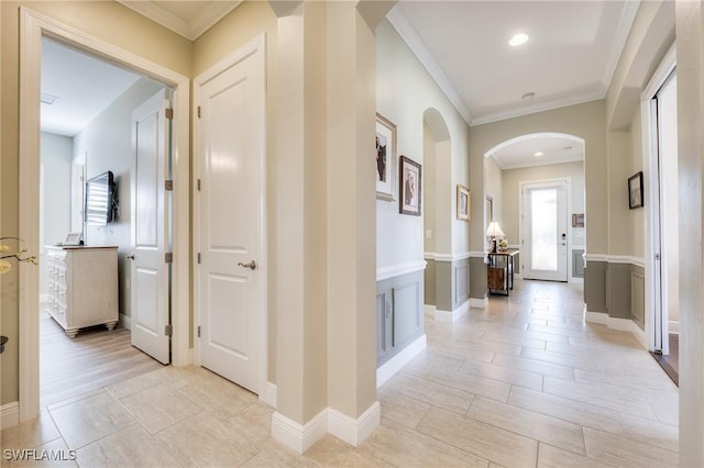 corridor with crown molding and light hardwood / wood-style floors