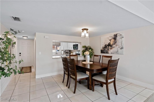 dining area featuring light tile patterned floors