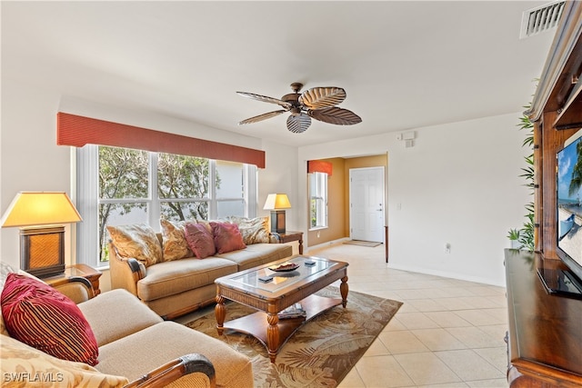 tiled living room with ceiling fan