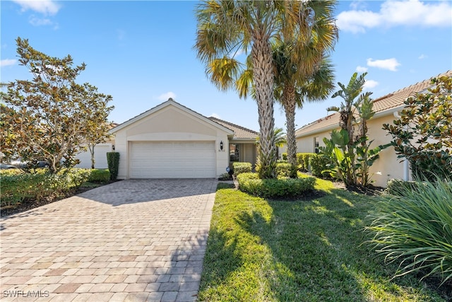 view of front of home with a garage and a front yard