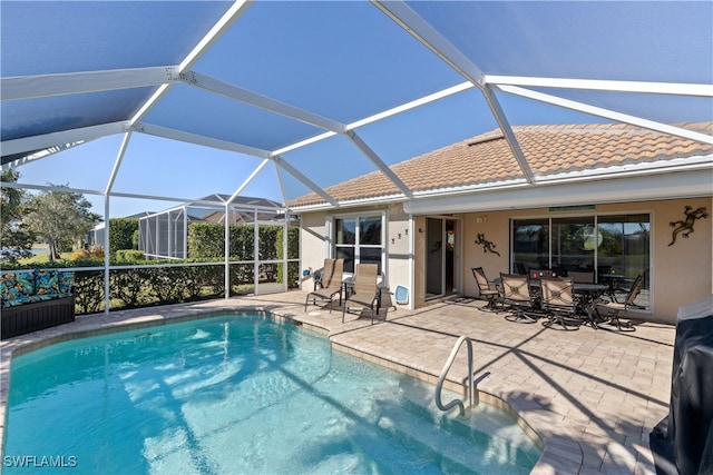 view of swimming pool featuring a patio and glass enclosure