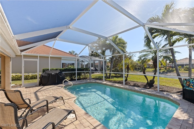 view of pool featuring a lanai, grilling area, and a patio area