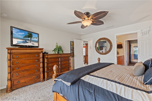 carpeted bedroom with ceiling fan and ensuite bathroom