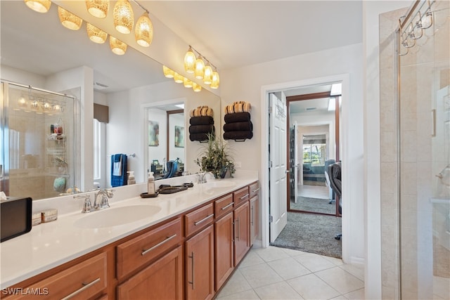 bathroom featuring vanity, tile patterned floors, and a shower with shower door