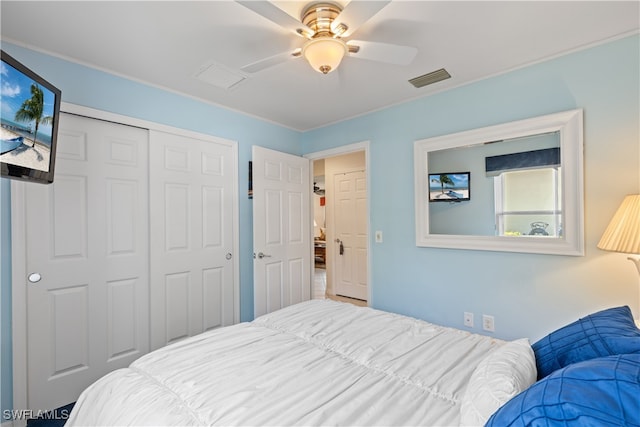 bedroom with ceiling fan and a closet