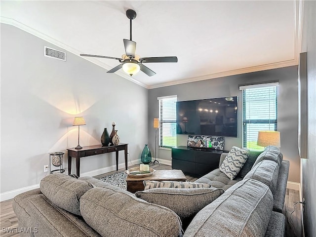 living room with ornamental molding, wood-type flooring, and ceiling fan