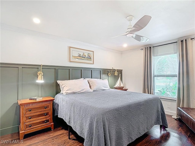 bedroom with crown molding, dark wood-type flooring, and ceiling fan