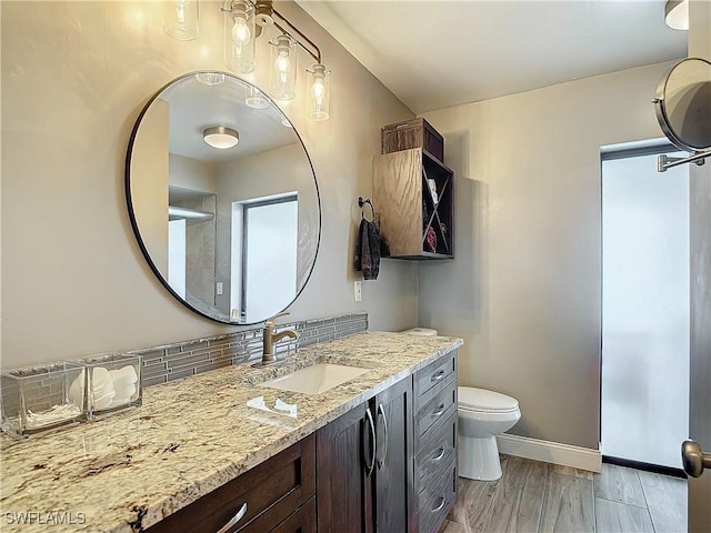 bathroom featuring hardwood / wood-style flooring, vanity, toilet, and decorative backsplash