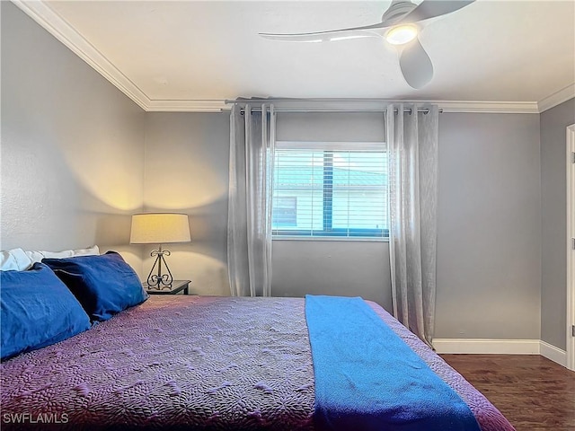 bedroom featuring ornamental molding, wood-type flooring, and ceiling fan