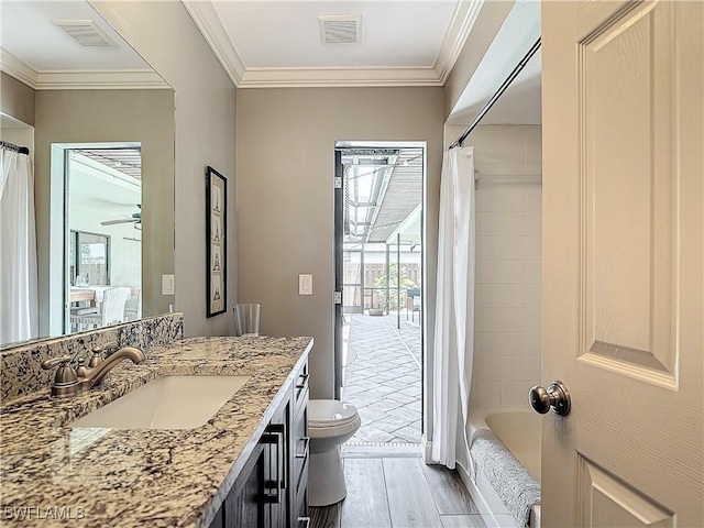 full bathroom featuring vanity, hardwood / wood-style flooring, ornamental molding, and toilet