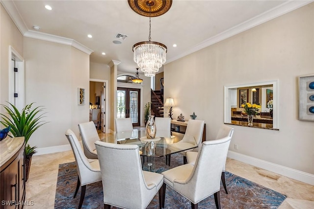 dining area featuring french doors, crown molding, and a chandelier