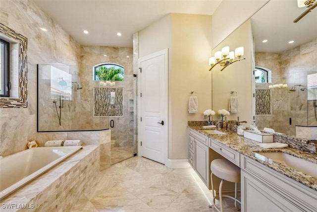 bathroom with vanity and separate shower and tub