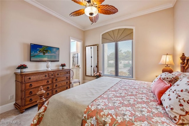 bedroom with crown molding, ceiling fan, and ensuite bathroom