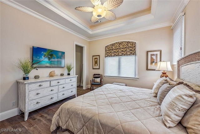 bedroom with a raised ceiling, ornamental molding, hardwood / wood-style floors, and multiple windows