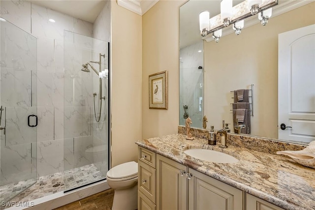 bathroom featuring hardwood / wood-style floors, vanity, an enclosed shower, toilet, and crown molding