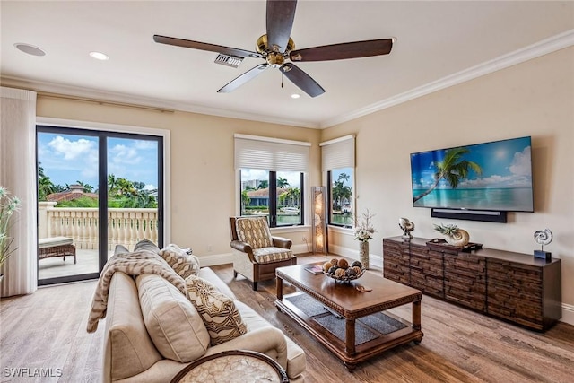 living room featuring crown molding, ceiling fan, and hardwood / wood-style flooring