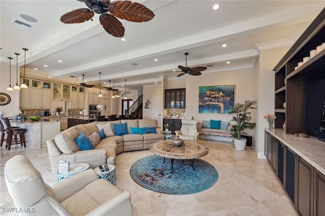 living room featuring beamed ceiling and ceiling fan