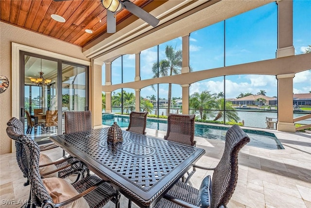 sunroom / solarium featuring a water view, ceiling fan with notable chandelier, a swimming pool, and wooden ceiling