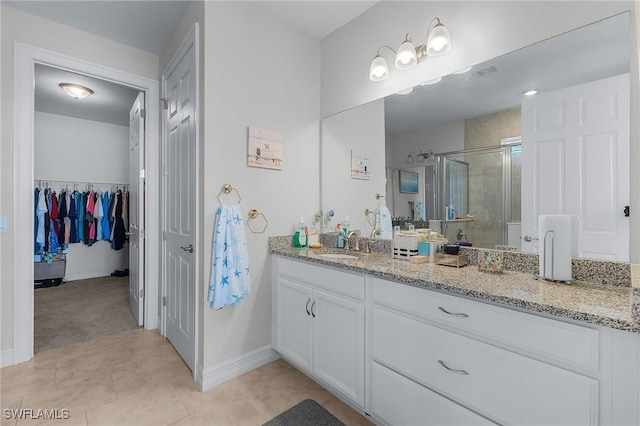 bathroom with tile patterned flooring, vanity, and an enclosed shower