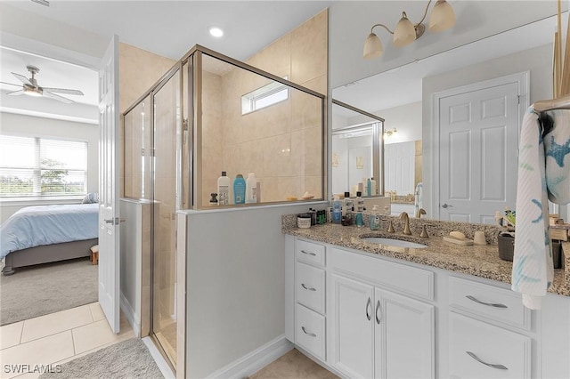 bathroom featuring vanity, plenty of natural light, tile patterned floors, and walk in shower