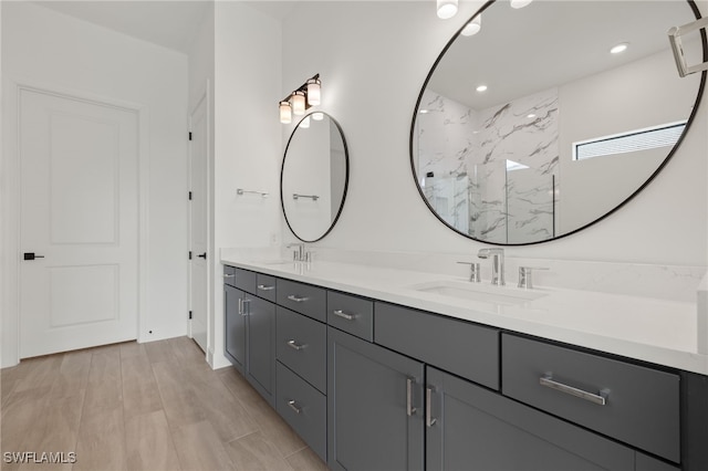 bathroom with vanity, hardwood / wood-style floors, and a shower