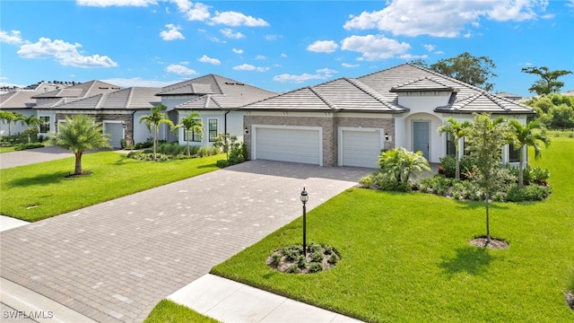 view of front of property featuring a garage and a front lawn