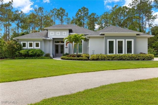 prairie-style house with a front lawn and french doors