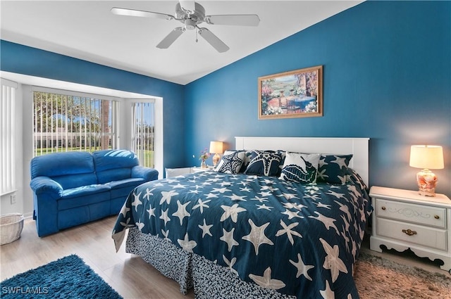 bedroom featuring vaulted ceiling, ceiling fan, and light wood-type flooring