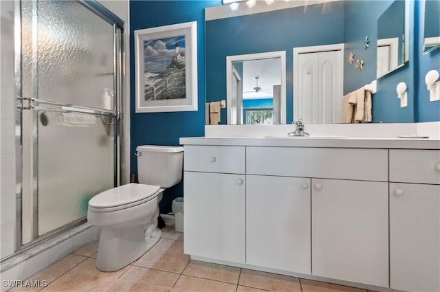 bathroom with walk in shower, vanity, toilet, and tile patterned flooring