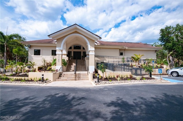 view of front of property with fence and stucco siding