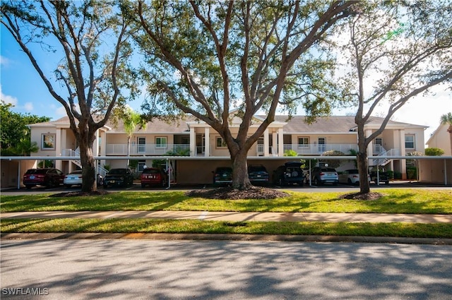 view of property featuring covered parking