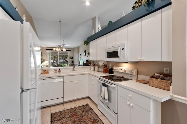 kitchen with white cabinetry, sink, light tile patterned floors, a notable chandelier, and white appliances