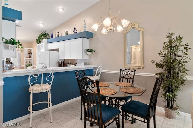 tiled dining space with a chandelier