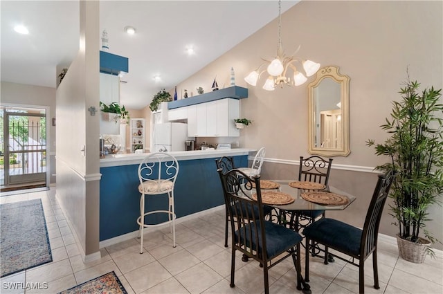 tiled dining area with a chandelier