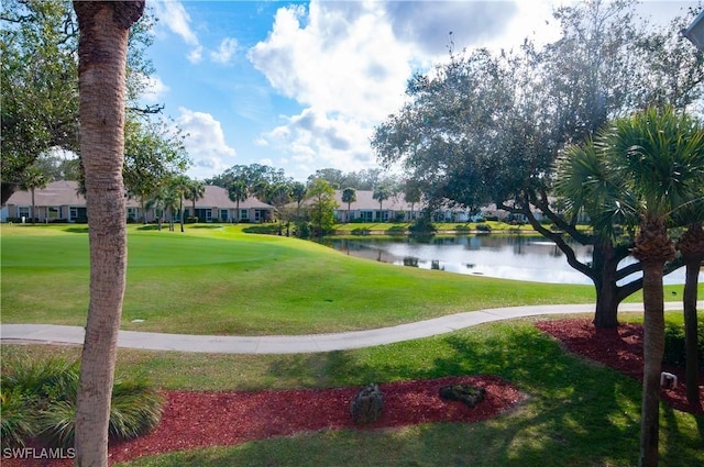 view of community with a water view and a lawn