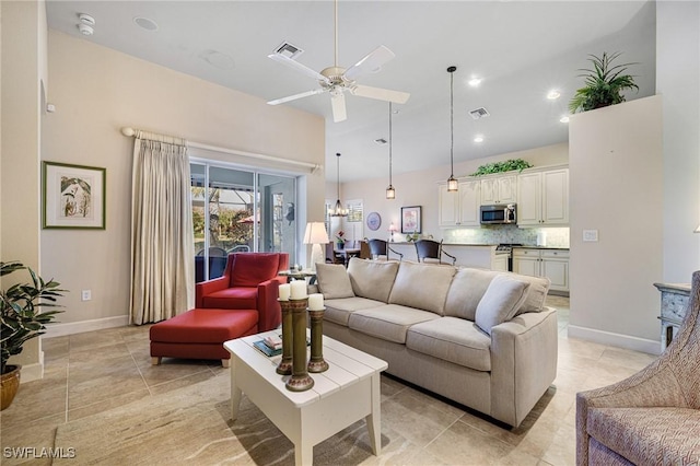 tiled living room featuring a towering ceiling and ceiling fan