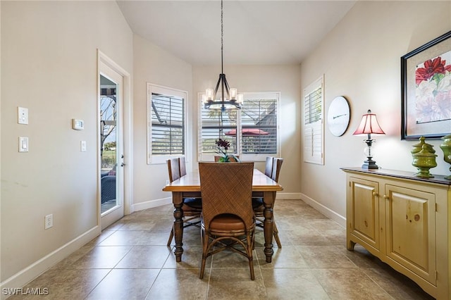 tiled dining space featuring a notable chandelier