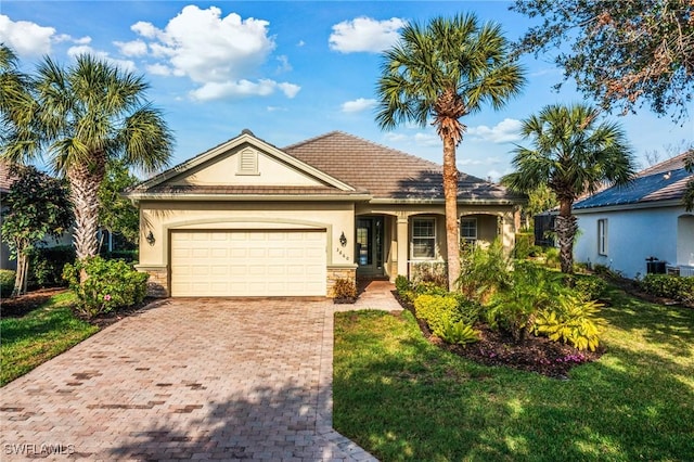 view of front of home featuring a garage and a front yard