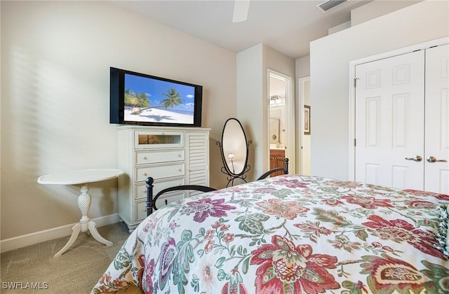 carpeted bedroom with ensuite bathroom, ceiling fan, and a closet